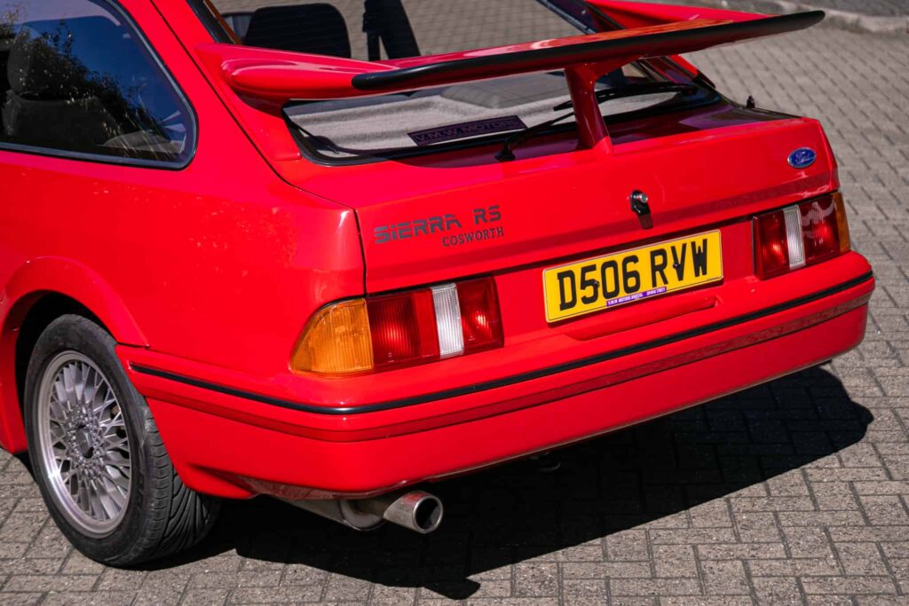 A rare Ford Sierra RS Cosworth in rosso red, once owned by a duke and racer, is set to fetch £90,000 at auction - over five times its original 1986 price.