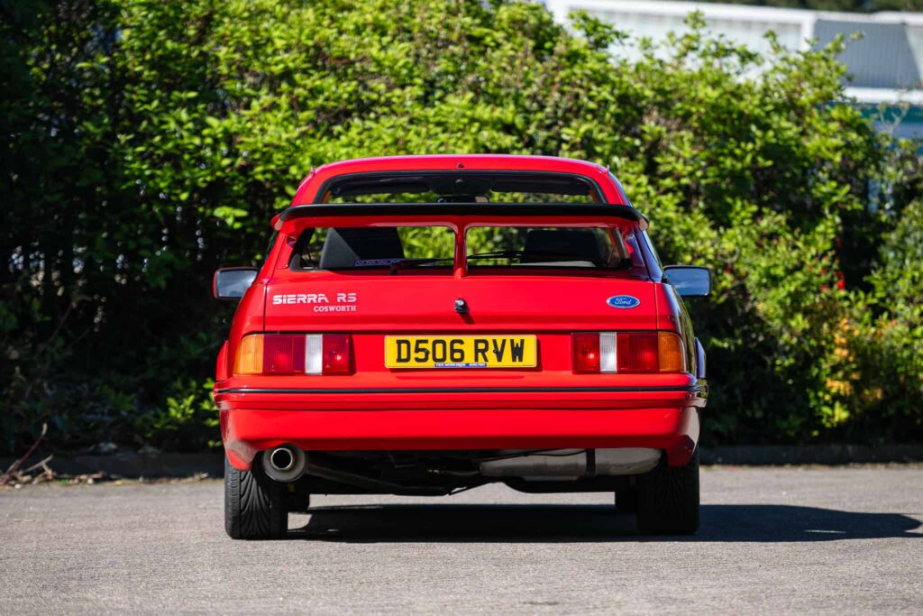 A rare Ford Sierra RS Cosworth in rosso red, once owned by a duke and racer, is set to fetch £90,000 at auction - over five times its original 1986 price.