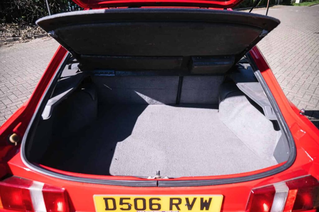 A rare Ford Sierra RS Cosworth in rosso red, once owned by a duke and racer, is set to fetch £90,000 at auction - over five times its original 1986 price.