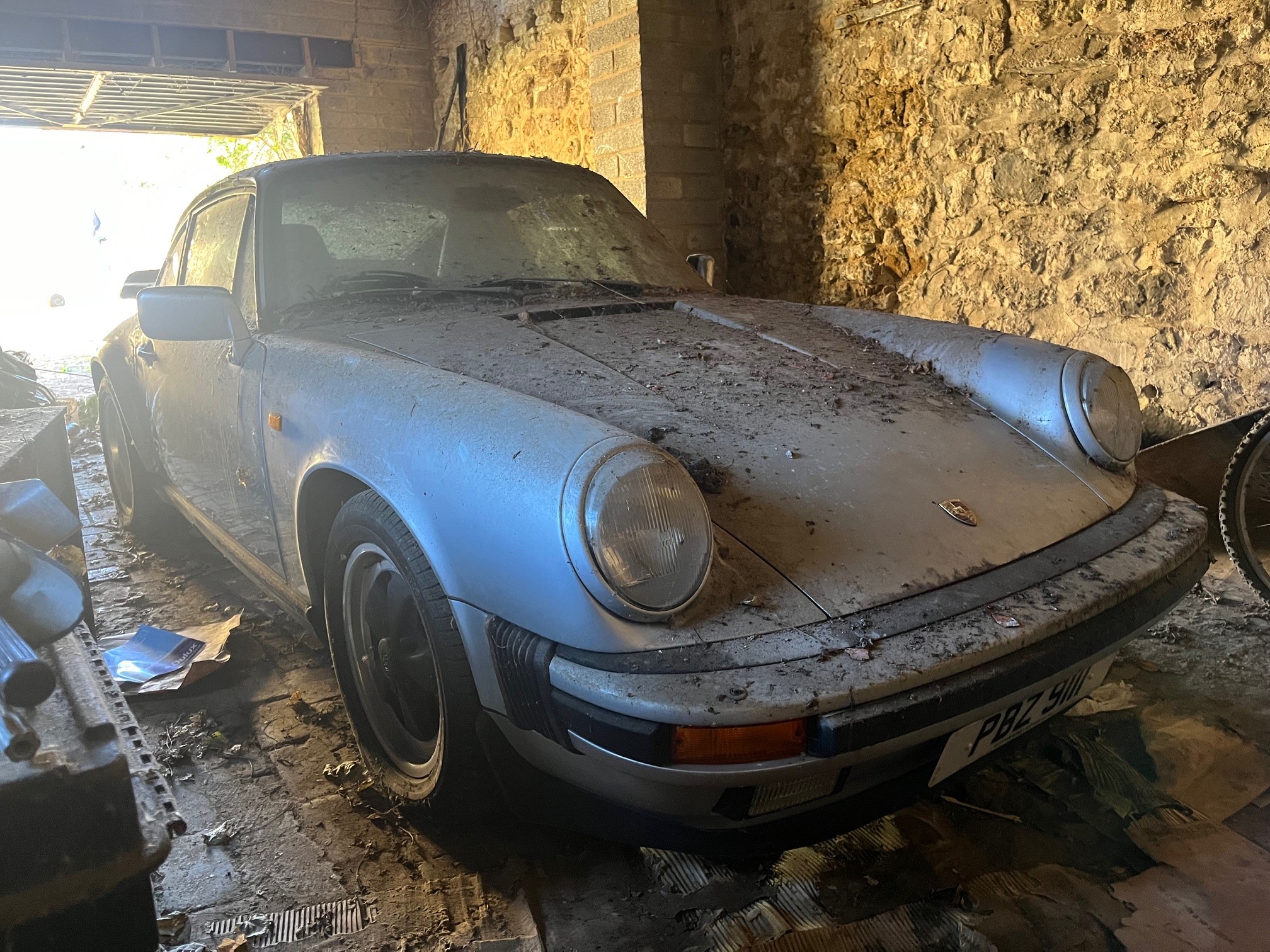 A barn-find 1989 Porsche 911 3.2 Carrera Sport with just 40,000 miles is up for sale at £25,000 after 14 years in storage, offering huge potential to collectors.