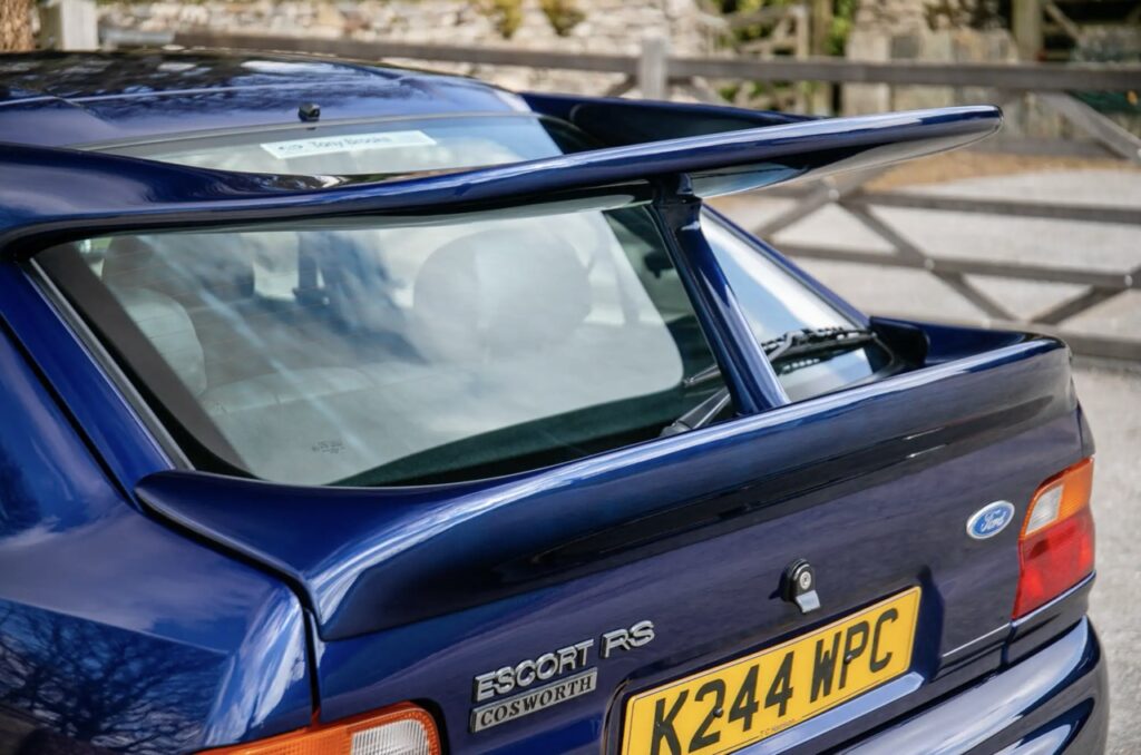 A rare 1993 Ford Escort RS Cosworth sold for £118,000 at auction, 12 times its original price, thanks to low mileage, one owner and iconic Big Turbo performance.