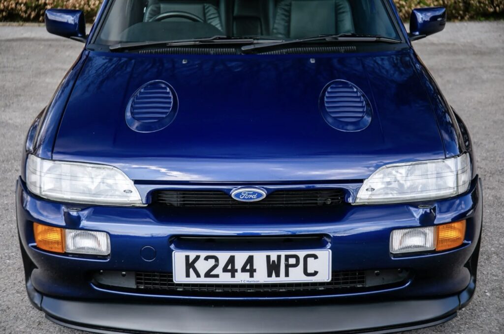 A rare 1993 Ford Escort RS Cosworth sold for £118,000 at auction, 12 times its original price, thanks to low mileage, one owner and iconic Big Turbo performance.