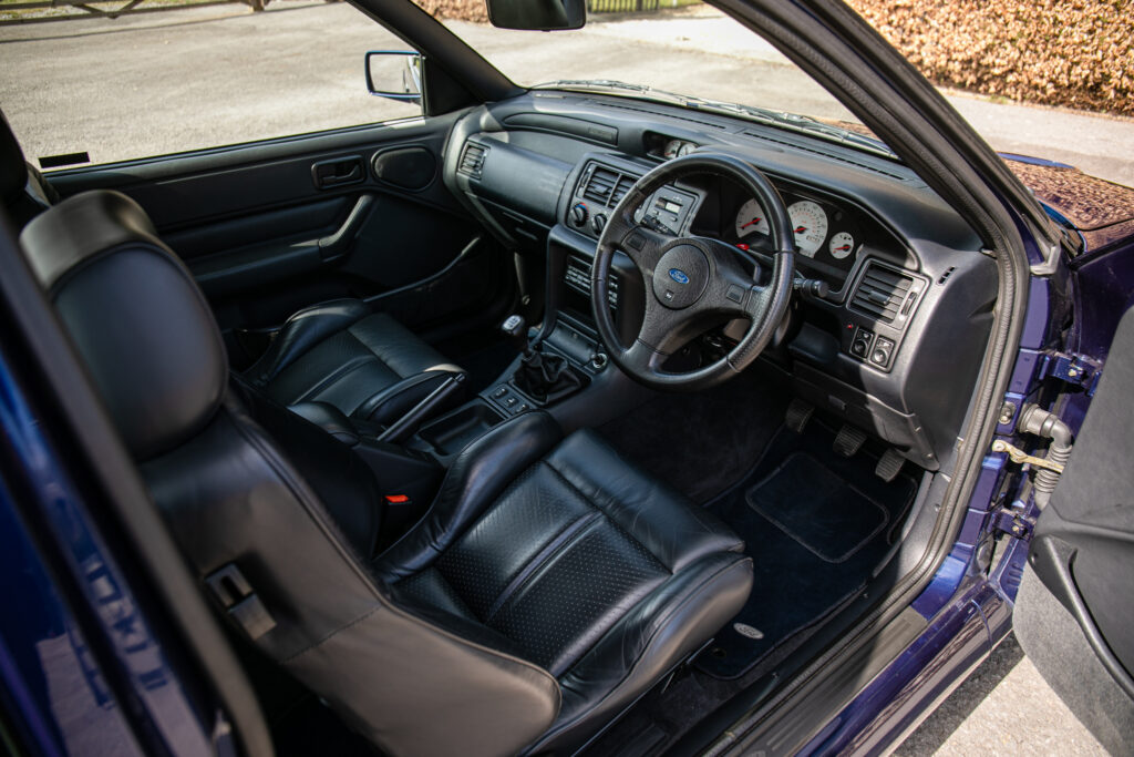 A rare 1993 Ford Escort RS Cosworth sold for £118,000 at auction, 12 times its original price, thanks to low mileage, one owner and iconic Big Turbo performance.