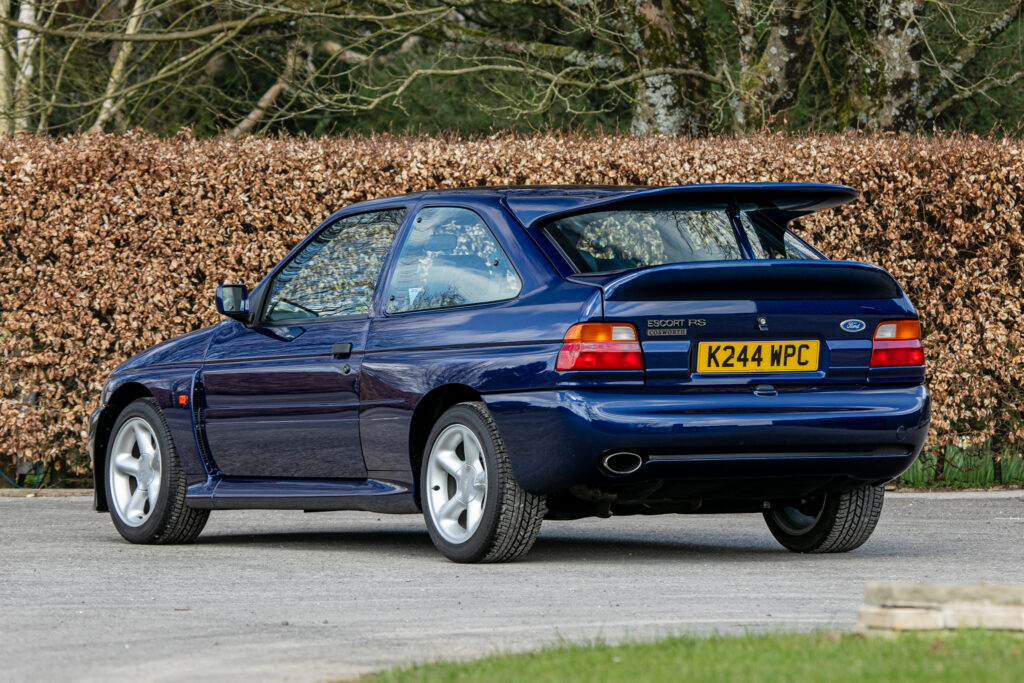 A rare 1993 Ford Escort RS Cosworth sold for £118,000 at auction, 12 times its original price, thanks to low mileage, one owner and iconic Big Turbo performance.