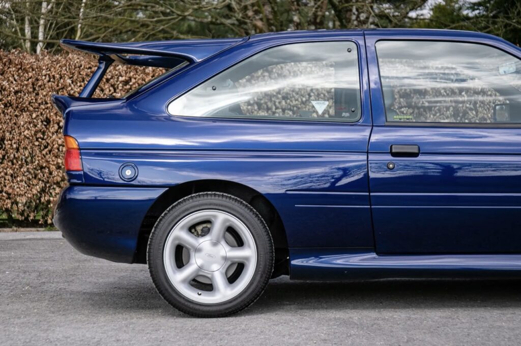 A rare 1993 Ford Escort RS Cosworth sold for £118,000 at auction, 12 times its original price, thanks to low mileage, one owner and iconic Big Turbo performance.