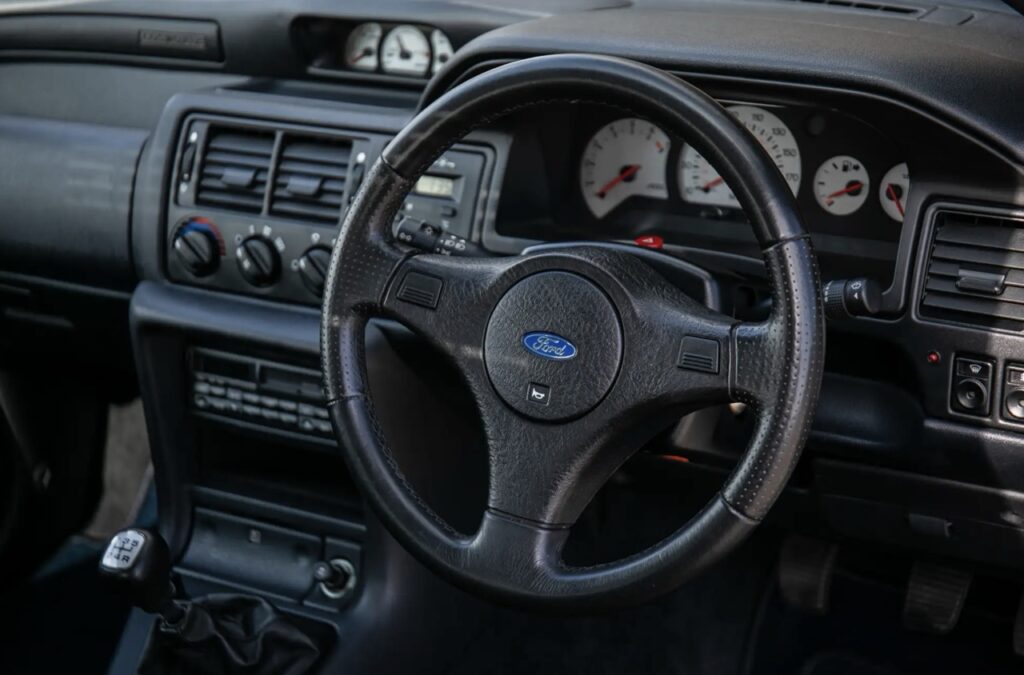 A rare 1993 Ford Escort RS Cosworth sold for £118,000 at auction, 12 times its original price, thanks to low mileage, one owner and iconic Big Turbo performance.